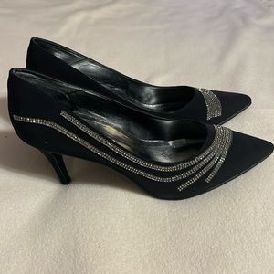 Black 9 1/2 dress pumps with design across front and side.